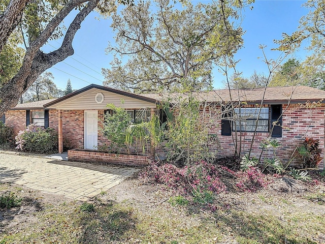 ranch-style house featuring brick siding