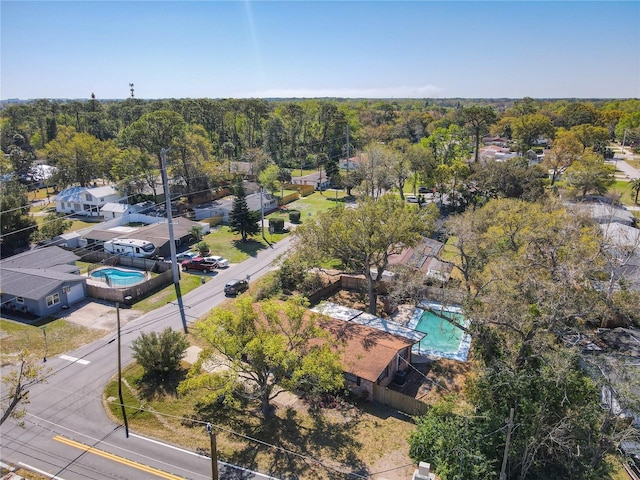 birds eye view of property featuring a view of trees