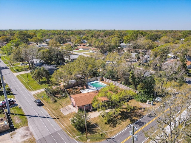 birds eye view of property with a view of trees