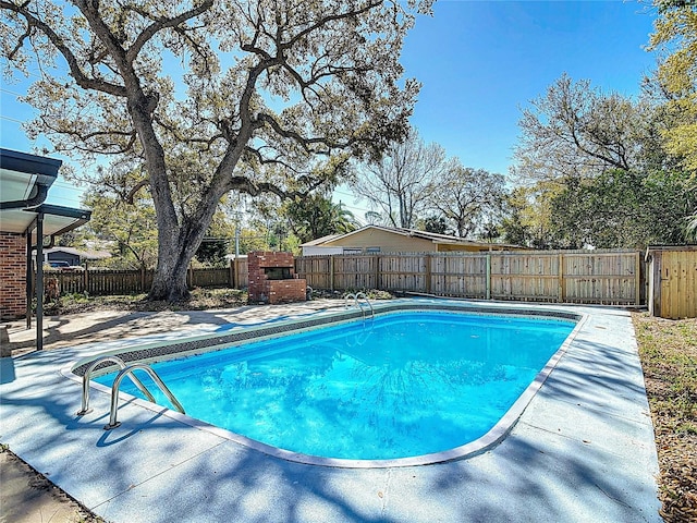 view of swimming pool featuring a fenced in pool, a patio, and a fenced backyard