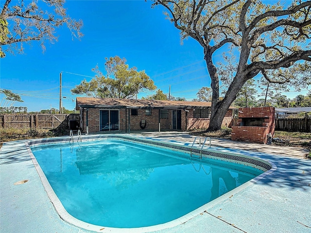 view of swimming pool with a patio area, a fenced in pool, and fence