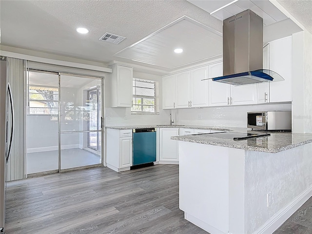 kitchen with wood finished floors, visible vents, dishwasher, stainless steel microwave, and island range hood