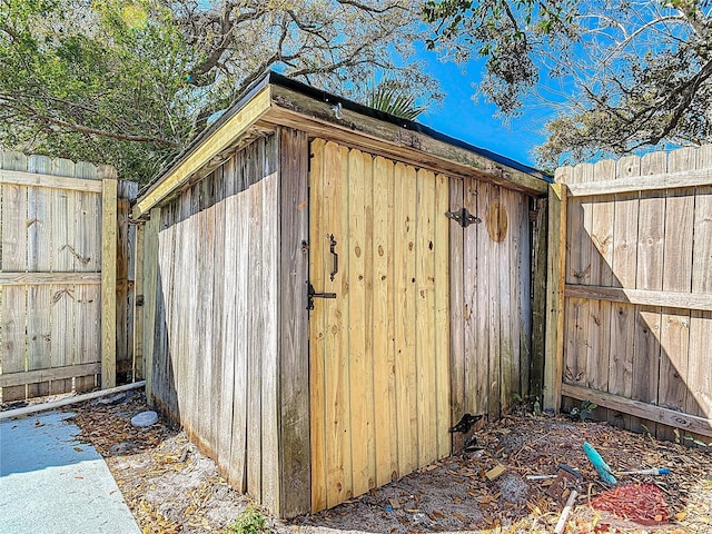 view of outbuilding with fence