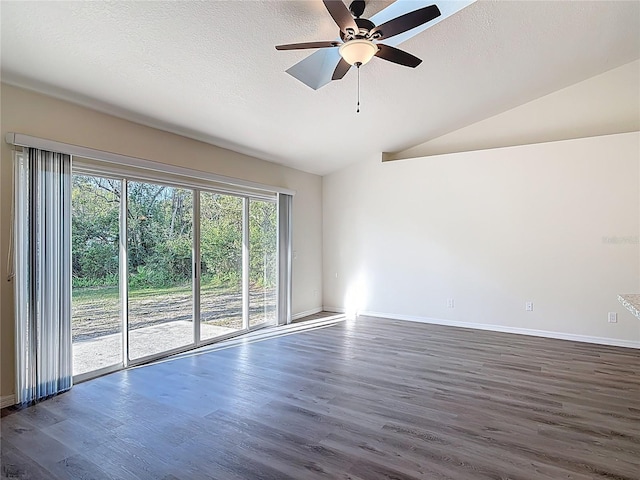 empty room with ceiling fan, a textured ceiling, dark wood finished floors, and vaulted ceiling