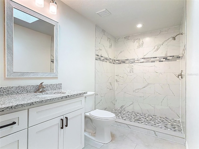 full bath featuring visible vents, vanity, toilet, and a shower stall