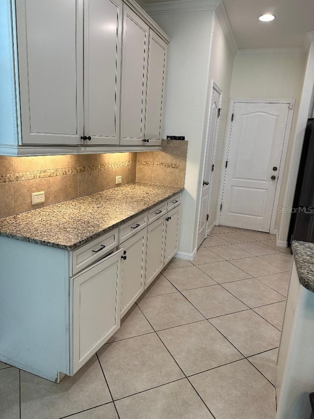 1812 Leather Fern Dr, Ocoee, FL 34761 - kitchen featuring freestanding refrigerator, decorative backsplash, light stone countertops, light tile patterned floors, and recessed lighting