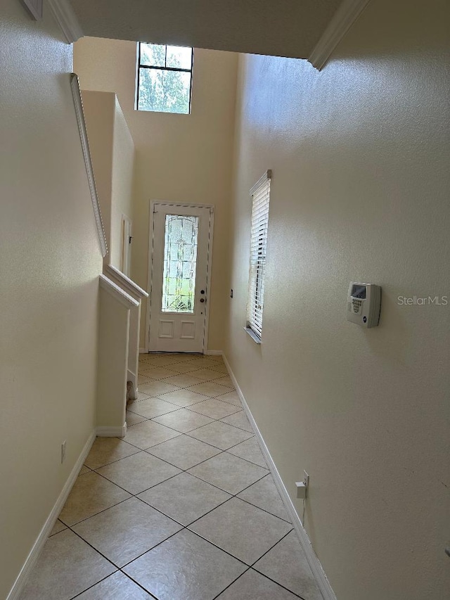 1812 Leather Fern Dr, Ocoee, FL 34761 - doorway featuring light tile patterned floors, baseboards, and a high ceiling
