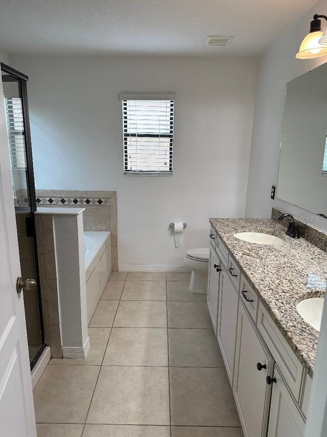 1812 Leather Fern Dr, Ocoee, FL 34761 - bathroom featuring double vanity, a bath, a stall shower, tile patterned flooring, and toilet