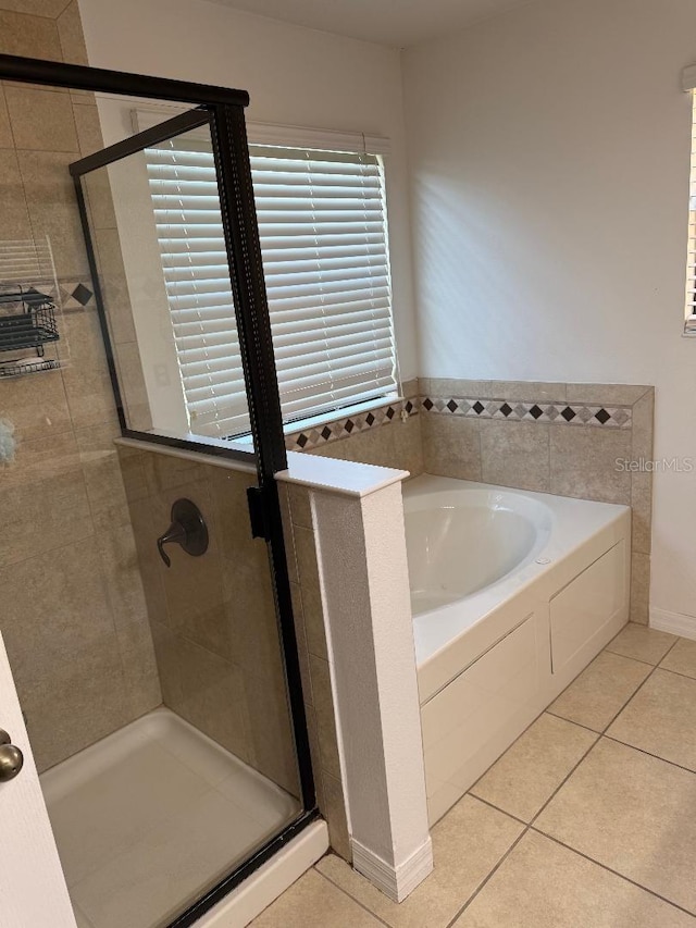1812 Leather Fern Dr, Ocoee, FL 34761 - bathroom featuring a bath, a stall shower, and tile patterned floors
