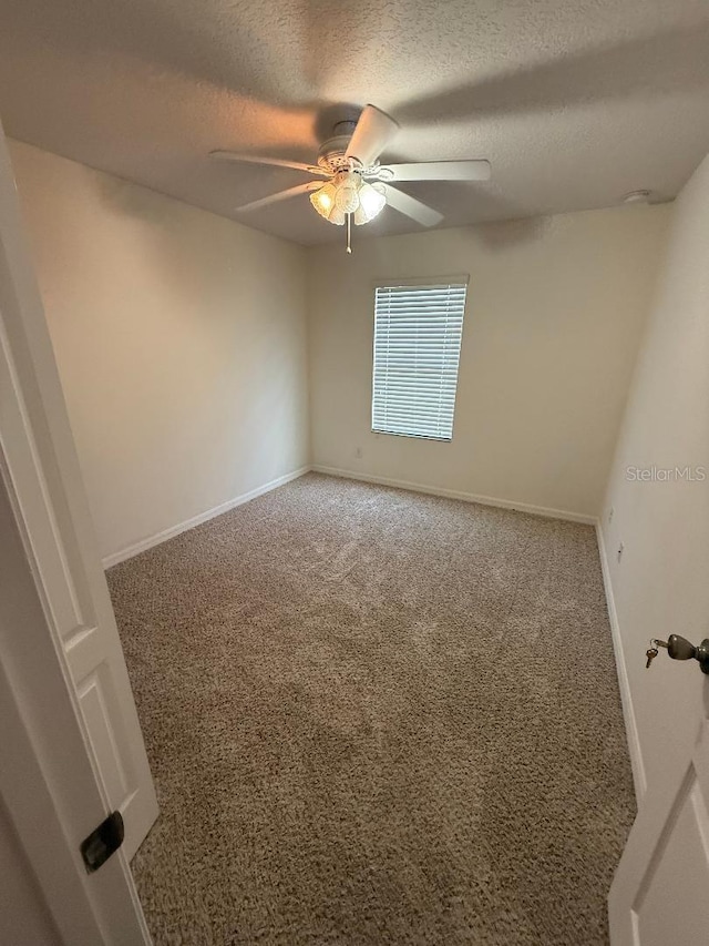1812 Leather Fern Dr, Ocoee, FL 34761 - carpeted empty room with ceiling fan, a textured ceiling, and baseboards