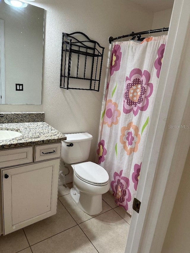 1812 Leather Fern Dr, Ocoee, FL 34761 - bathroom featuring vanity, toilet, tile patterned flooring, curtained shower, and a textured wall