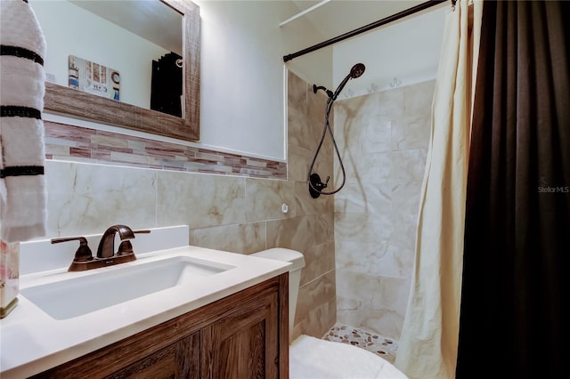 bathroom featuring a shower stall, vanity, tile walls, and toilet