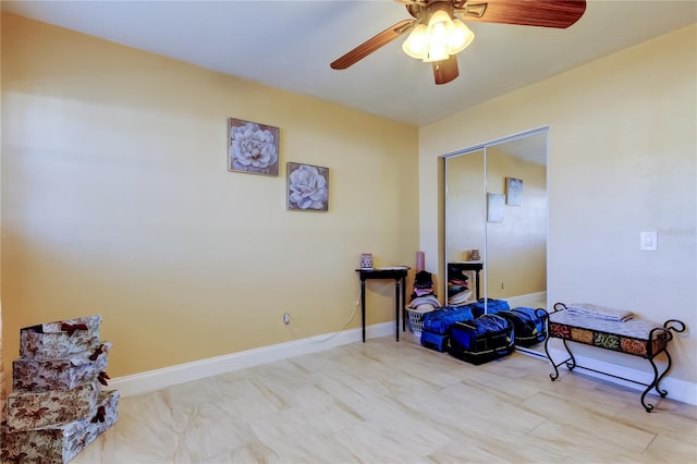 miscellaneous room featuring baseboards and ceiling fan