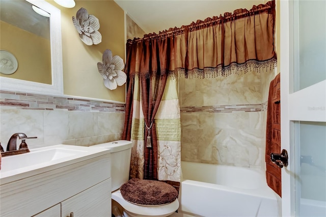 bathroom with tile walls, toilet, shower / bath combo, wainscoting, and vanity