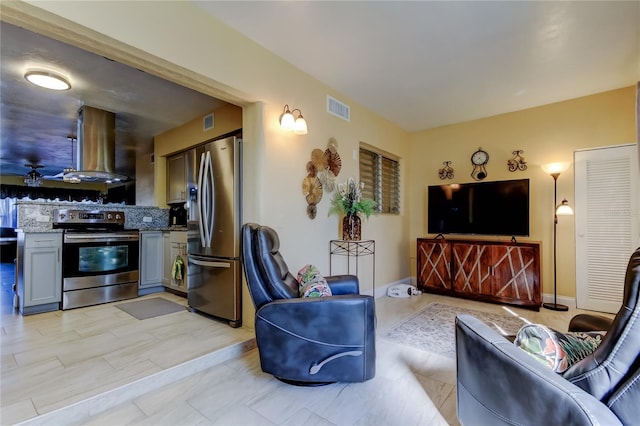 living area featuring visible vents and baseboards