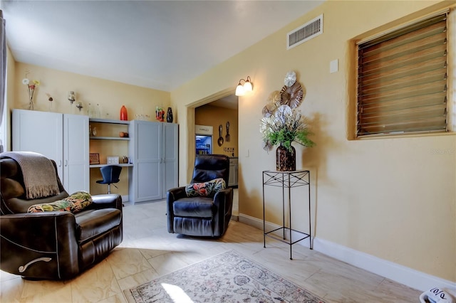 sitting room with visible vents and baseboards