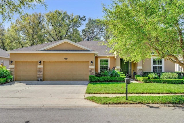 view of front of home with an attached garage, stone siding, driveway, and stucco siding