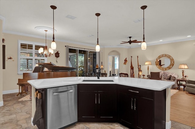 kitchen with open floor plan, light countertops, ornamental molding, stainless steel dishwasher, and a sink