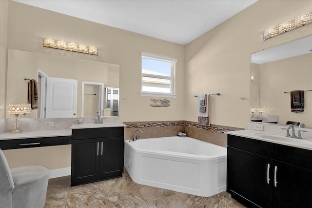 full bathroom featuring a shower stall, two vanities, a garden tub, and a sink