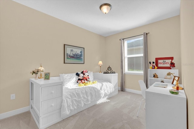 bedroom featuring light colored carpet and baseboards