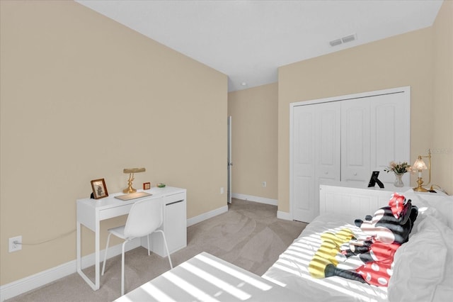 bedroom featuring light carpet, visible vents, a closet, and baseboards