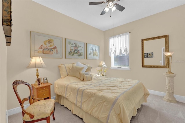 bedroom with light carpet, ceiling fan, and baseboards