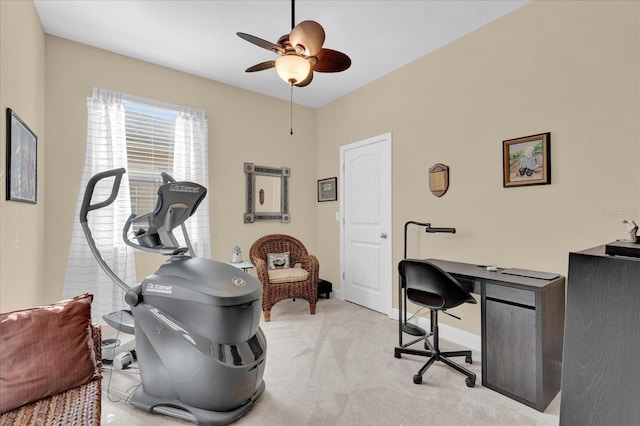 office featuring light colored carpet, baseboards, and a ceiling fan