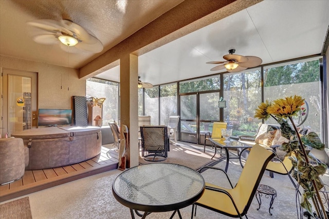 sunroom featuring a ceiling fan