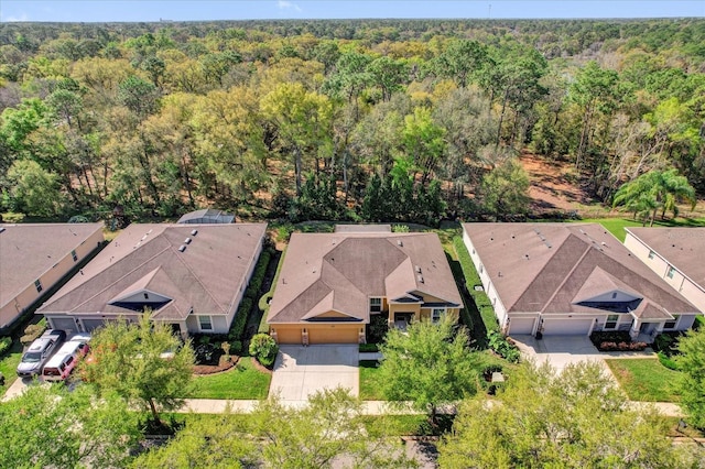 aerial view with a wooded view and a residential view