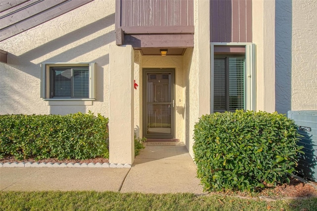 property entrance with stucco siding