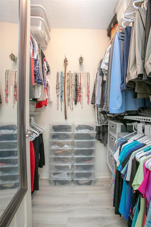 walk in closet featuring wood finished floors