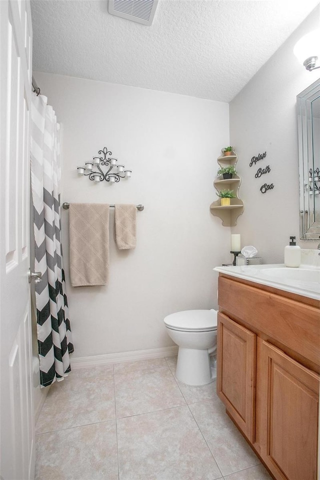 full bath with visible vents, toilet, vanity, tile patterned floors, and a textured ceiling