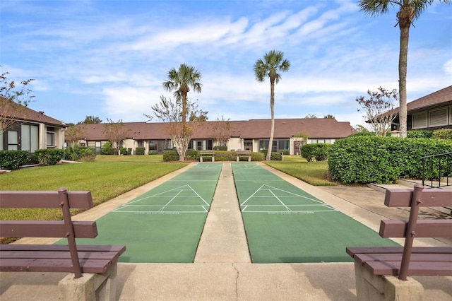 view of property's community featuring a residential view, shuffleboard, and a lawn