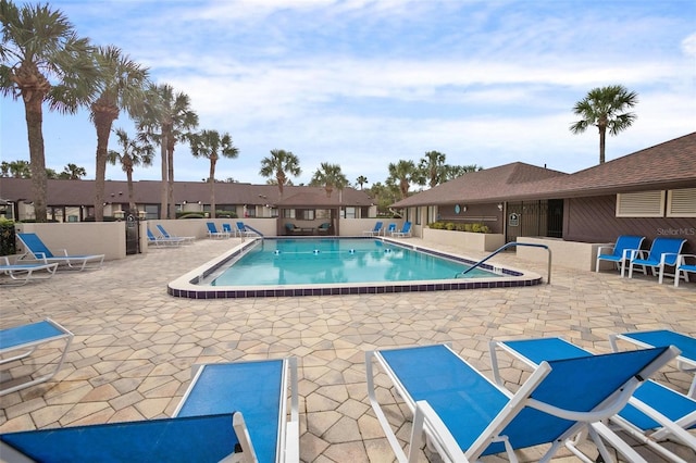 pool featuring a patio area and fence