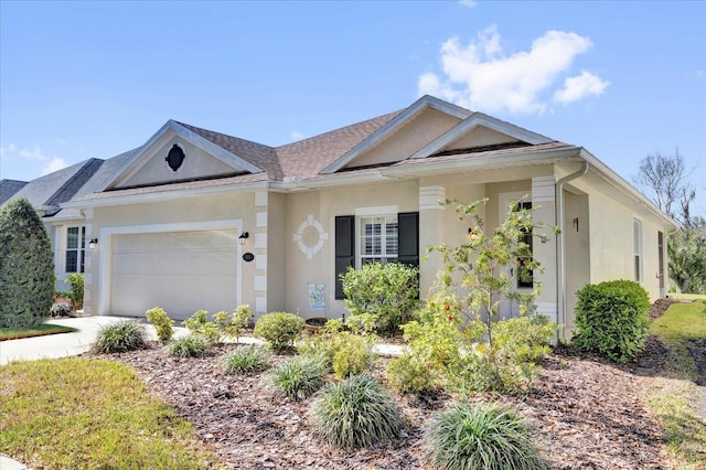 single story home with stucco siding, an attached garage, and concrete driveway