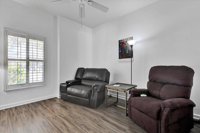 living area featuring ceiling fan, baseboards, and wood finished floors