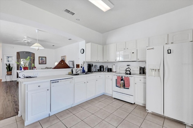 kitchen featuring visible vents, a peninsula, white appliances, white cabinetry, and a sink