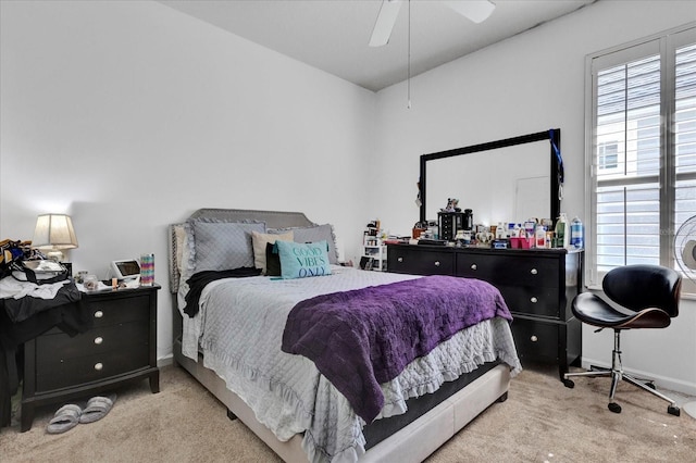 bedroom with a ceiling fan, baseboards, and carpet floors