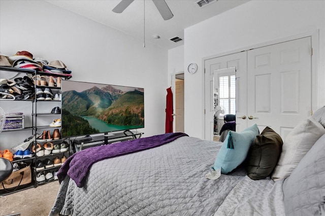 carpeted bedroom with visible vents, a closet, and a ceiling fan