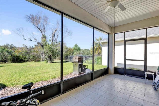 unfurnished sunroom featuring a ceiling fan