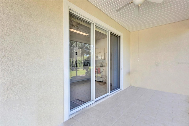 exterior space featuring stucco siding and a ceiling fan