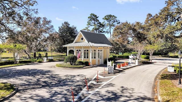 view of road with curbs and a gated entry