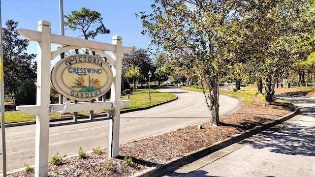 view of street with street lights and curbs