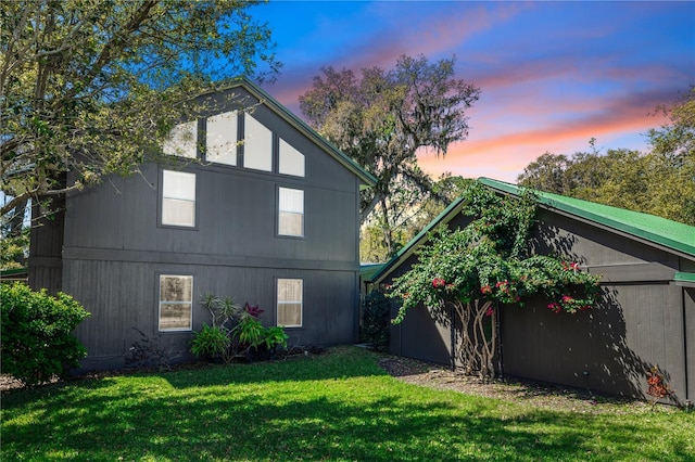 rear view of property with a lawn