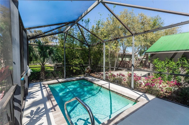 view of pool with a patio and a lanai