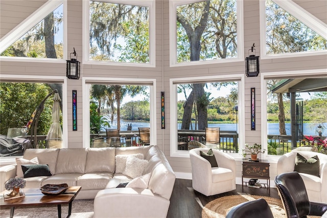 sunroom / solarium with a wealth of natural light and a water view