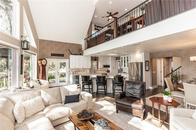 living area featuring stairway, wine cooler, french doors, ceiling fan, and dark wood-style flooring