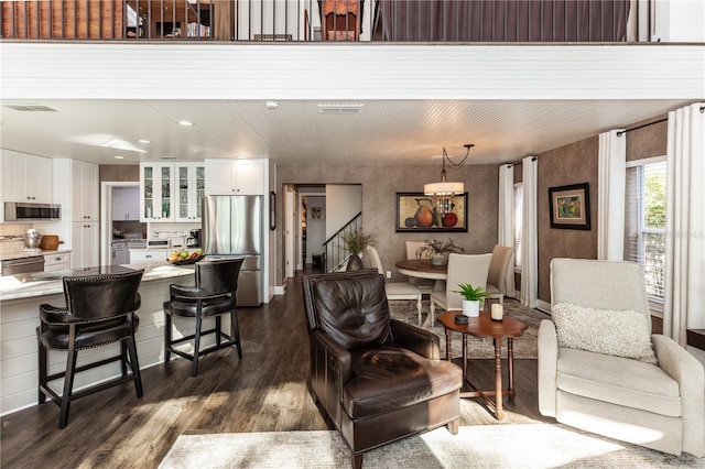 living area featuring dark wood-type flooring and visible vents