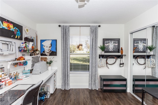 office with baseboards, a textured ceiling, and wood finished floors