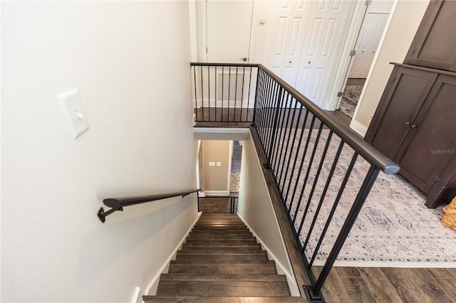 stairway featuring baseboards and wood finished floors